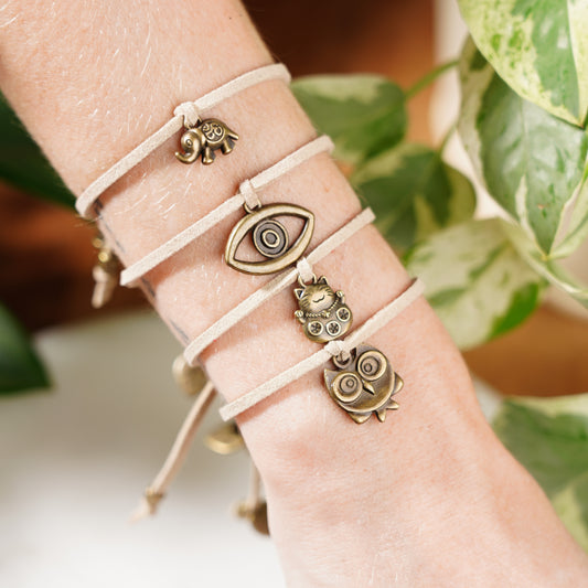 lucky charm bracelet set in beige evil eye lucky cat owl and elephant